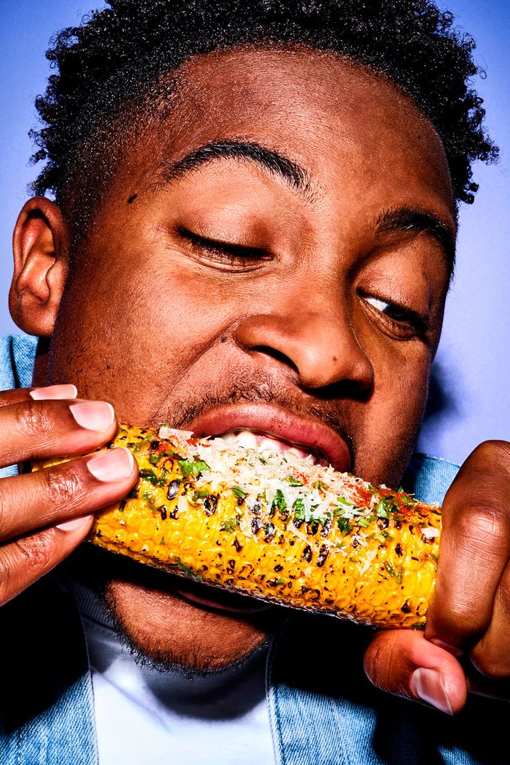 Guest eating grilled corn