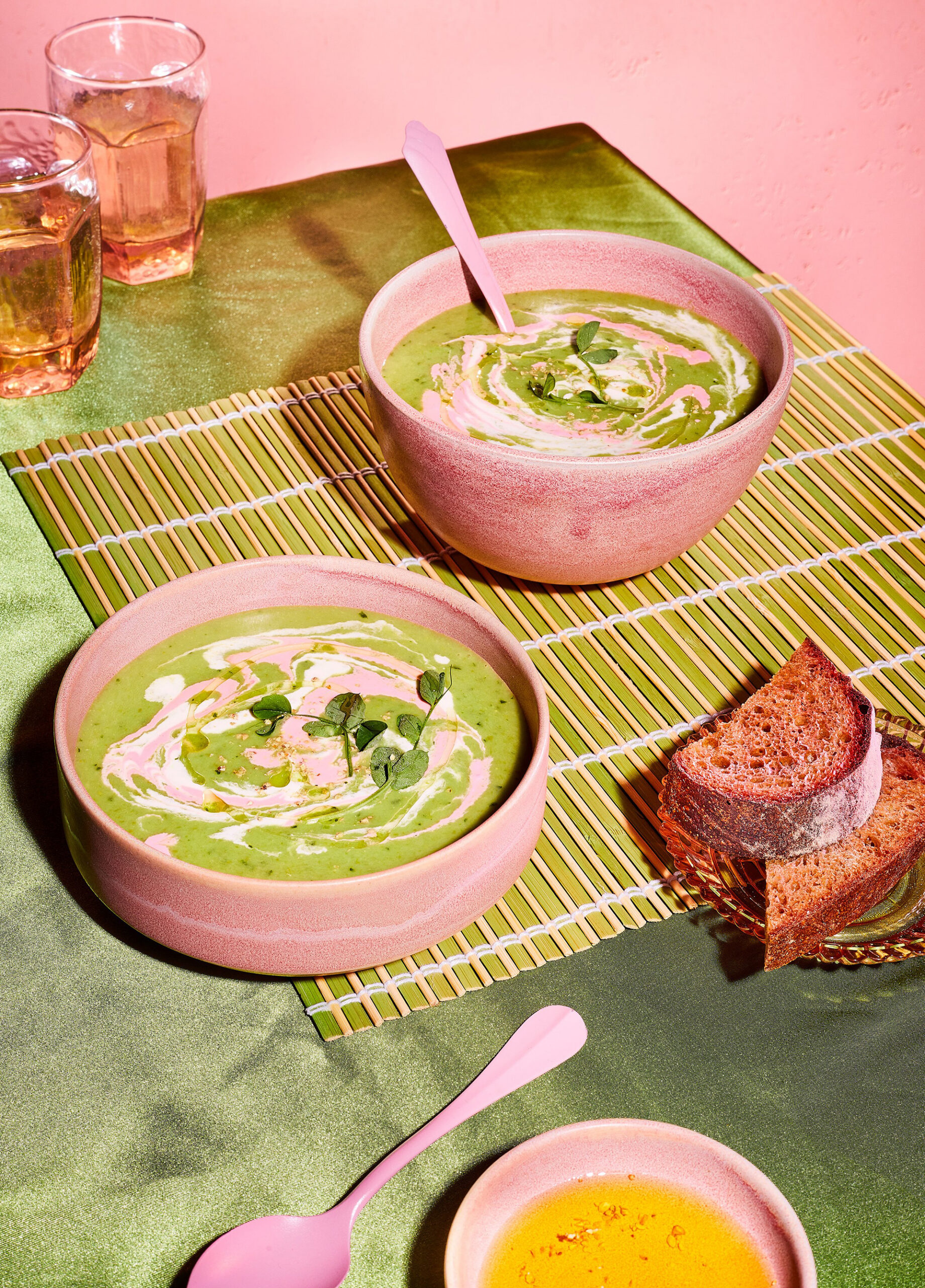 Green soups and bread on a table