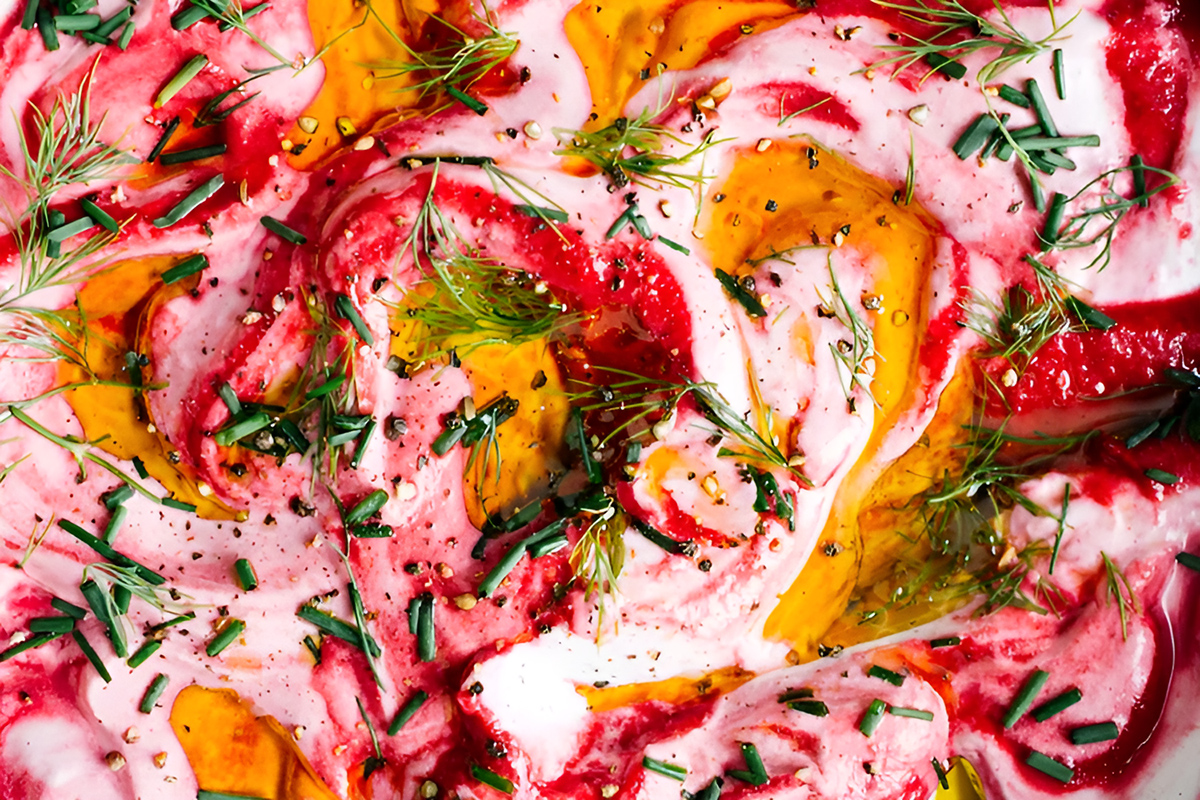 Vibrant beet and citrus salad on a pink table