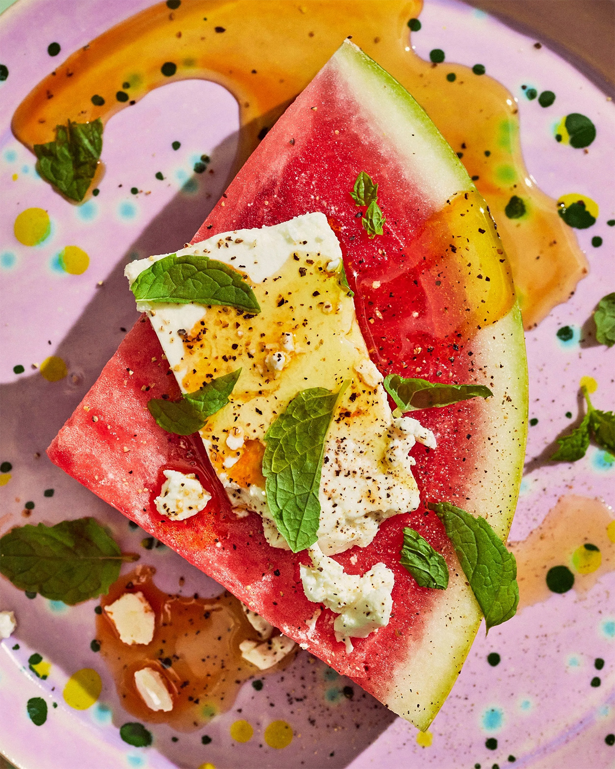 Watermelon slice with cheese, herbs, and seeds