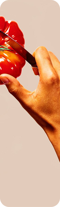 Chef slicing a tomato