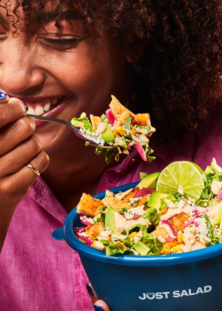 Guest enjoying a vibrant salad with lime garnish